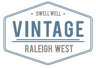 A logo for Dwell Well Vintage Raleigh West.
